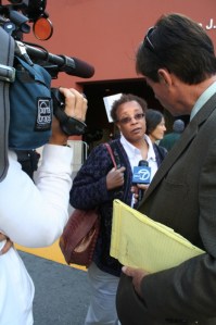 A protester outside the meeting speaks to the media about impending furloughs and pay cuts. Photo by Jenny Cain.