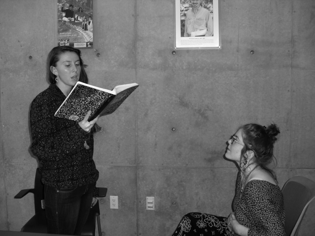Jacqueline Grohs (left) shares her poetry with fellow KPP organizer Alexandra Moskow (right). Photo by Gabrielle Garcia.