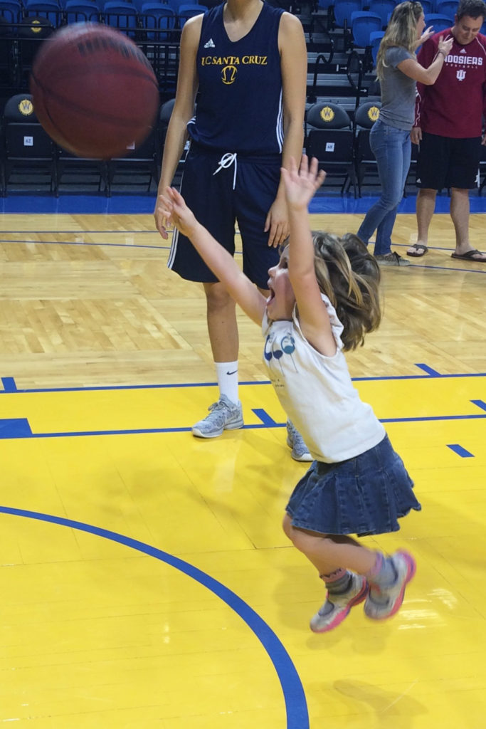 Four-year old Hazel Kent shoots the ball at one of  UCSC women’s basketball’s game day clinics this past year. Photos courtesy of Todd Kent.