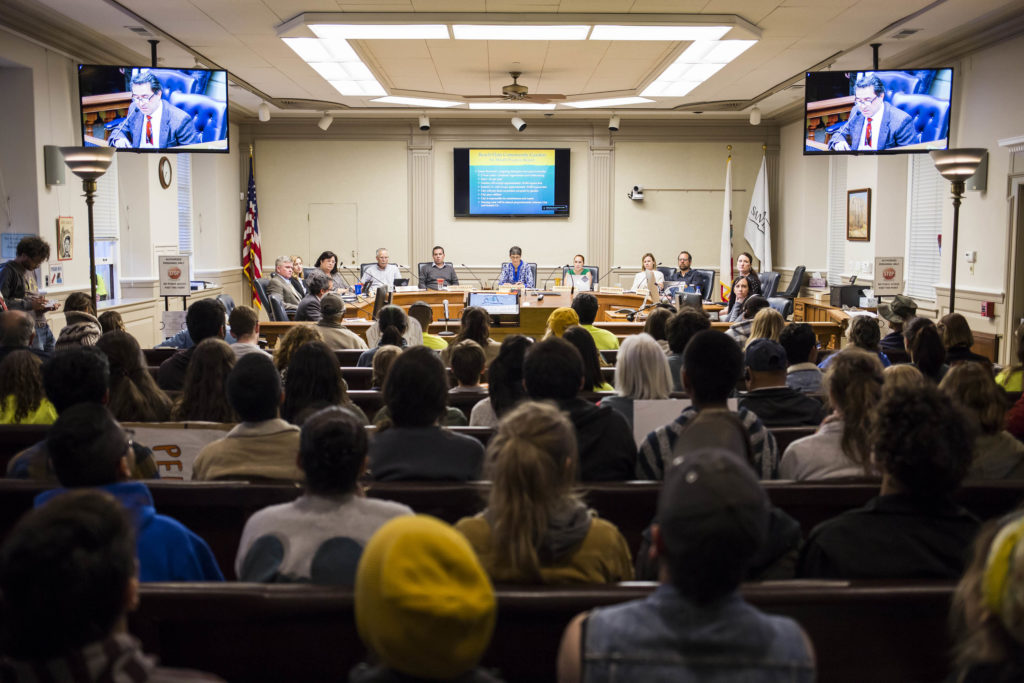 The Santa Cruz City Council sits before an audience of Beach Flats Garden supporters to address updates in regards to the future of the space. Santa Cruz Director of Parks and Recreation Mauro Garcia (on screen) reviews the signed lease agreement. Photo by Jasper Lyons